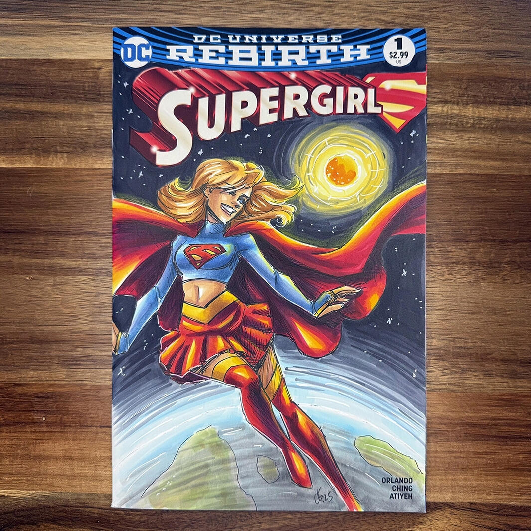 A blank sketch variant with Supergirl featuring her newest costume. She's floating above the atmosphere of Earth, with the sun and galaxy framing her.