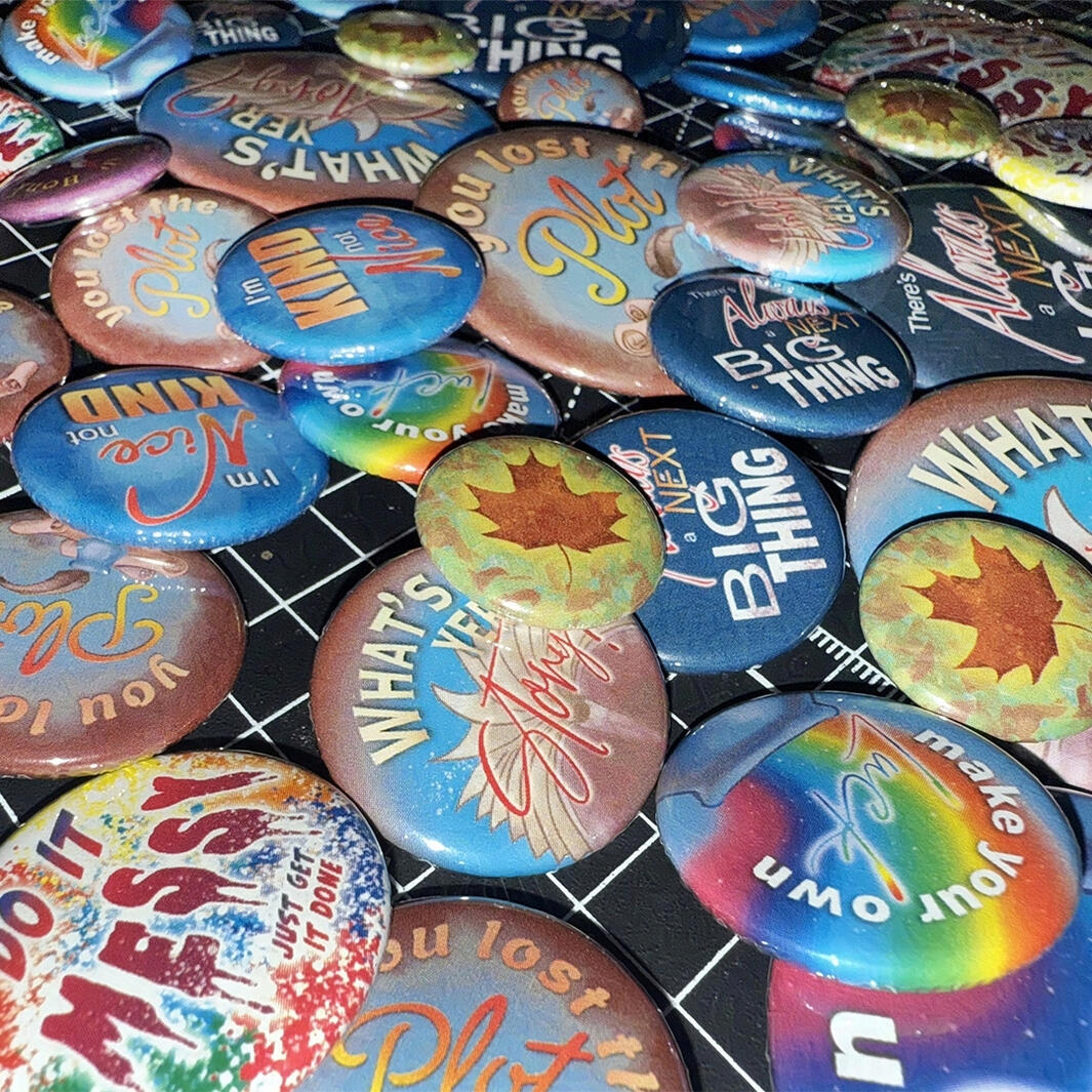 A spread of various pinback buttons and magnets.